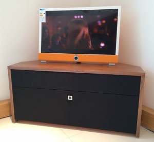 Audio Cabinet Tamzin Corner Unit shown in Walnut with Black grille cloth and SoundBar Aperture