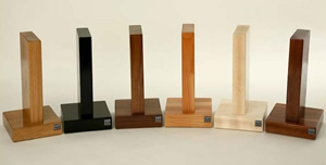 Hi-Fi Racks Headphone Holder / Stand, hand-made from Solid Wood. From Left to right: Oak, Satin Black, Walnut, Cherry, Maple and Mahogany.
